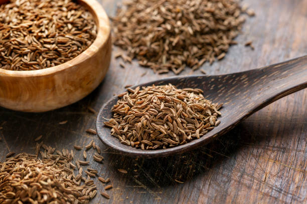 Caraway seeds, wooden spoon