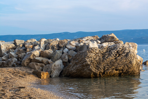 A huge stone worm on the coast of Croatia. Rocky seashore