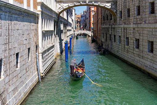 Gondola at famous Dodge's Palace with Sighs Bridge and canal at City of Venice on a sunny summer day. Photo taken August 7th, 2023, Venice, Italy.