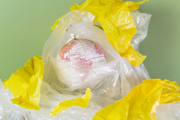 istock The Earth surrounded by plastic on a green background. Horizontal. 1958055192
