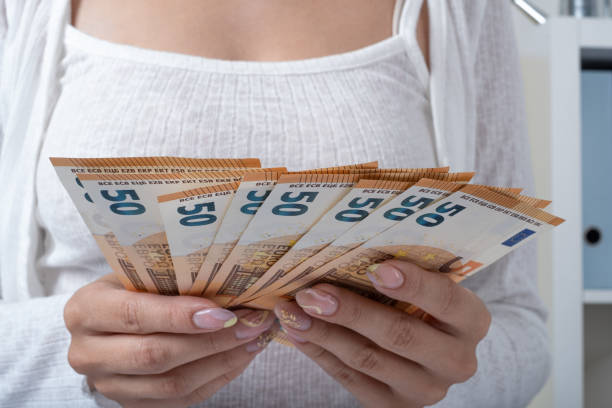 istock Women hold euros in their hands 1958060893