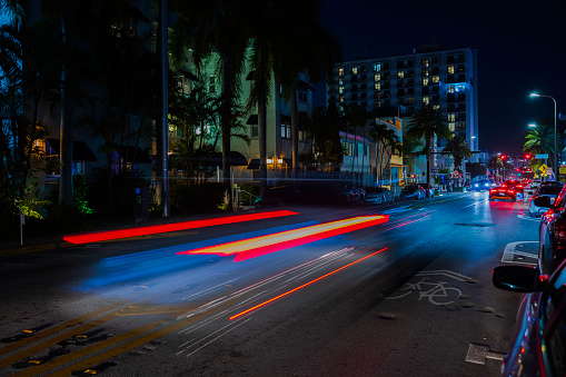 USA. Miami Beach. 01.25.2024. Beautiful night view of the cityscape with stunning blurred light trails from cars on the Miami Beach.