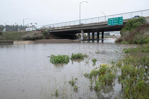 Oceanside, California, USA - January 22, 2024: 78 Freeway under overpass at El Camino Real was heavily flooded by a winter storm that dumped over 3 inches of rain in the region.