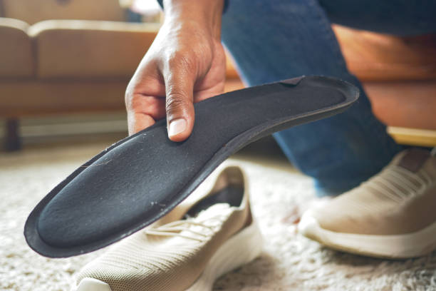 istock men hand putting Orthopedic insoles in shoes 1958070361