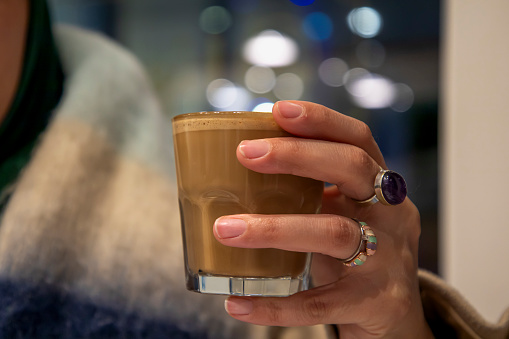 A person drinking coffee in a cafe