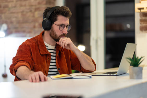 istock Young man working and looking involved and serious 1958114171