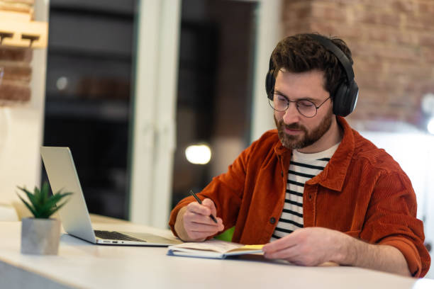 istock Young man working and looking involved and serious 1958114683
