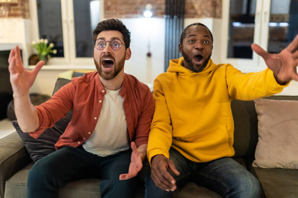 istock Two friends spending time together watching tv and looking excited 1958116381