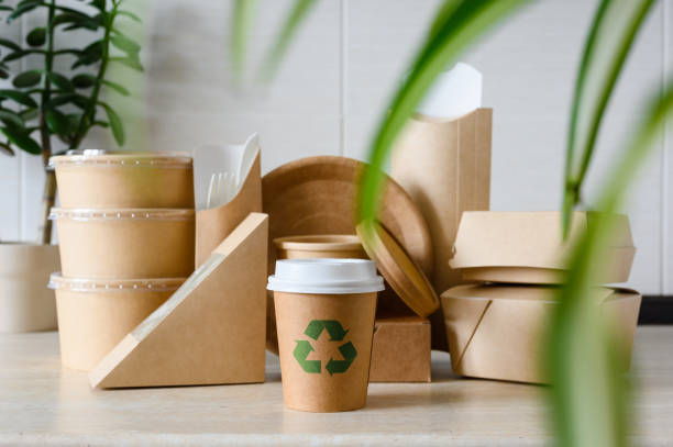 istock Recycling sign on a paper cup. Paper eco-friendly disposable tableware with green plants. selective focus. zero waste concept 1958142780