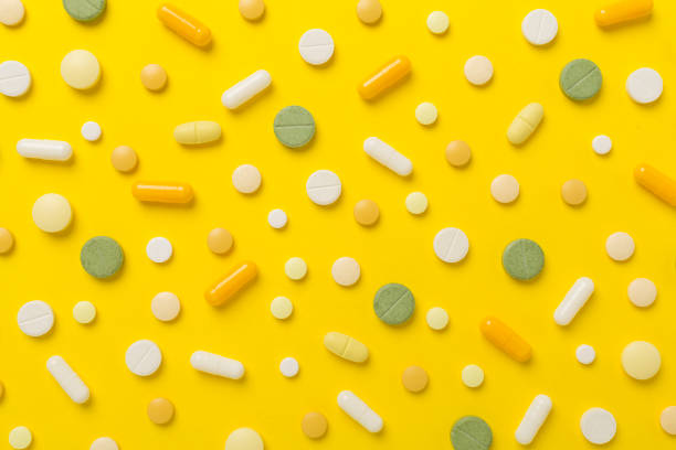 istock Flat lay with different medical pills and capsules on color background 1958150570
