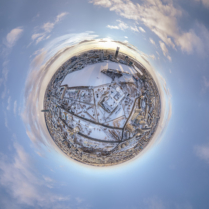 Aerial winter city view with crossroads and roads, houses, buildings, parks and bridges. Copter shot. Little planet sphere mode. Spherical panorama of the city, little planet. Yekaterinburg, Russia.