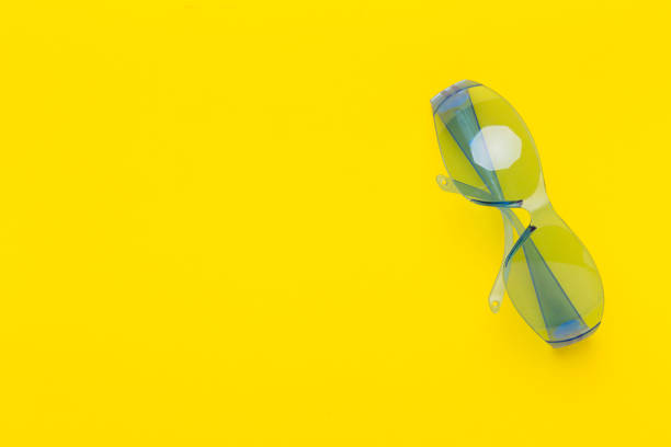 istock Safety glasses on color background, top view 1958167934