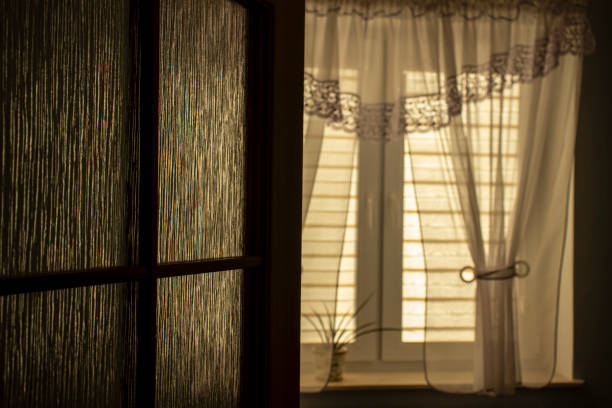 istock Day and night view through the window with indoor blinds in a room. 1958180425