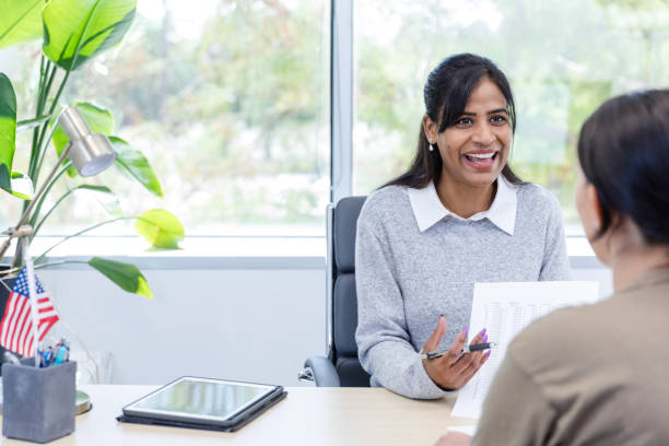 istock Mid adult female financial advisor asks her client questions 1958185714
