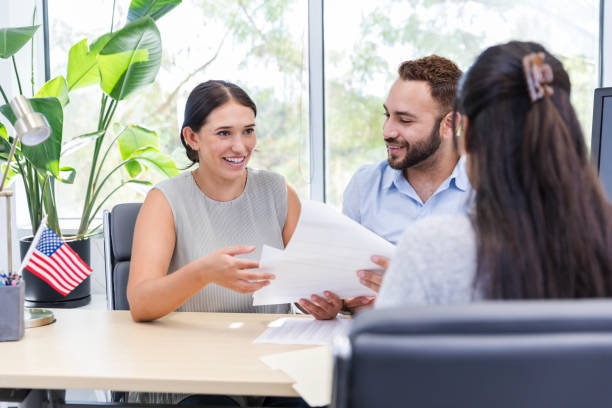 istock Excited female smiles while reading mortgage loan information 1958186240