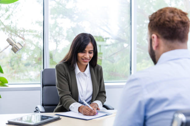 istock Female businesswoman writes down information while interviewing the candidate 1958186244