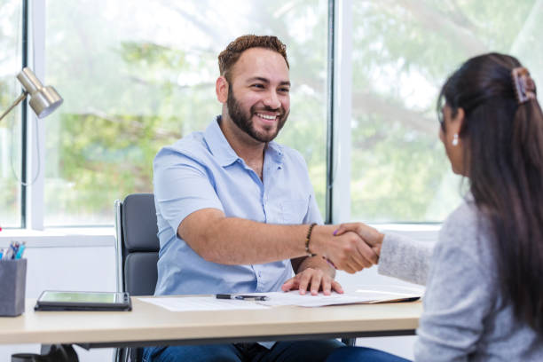 istock Male supervisor shakes hands with the unrecognizable female trainer 1958186797