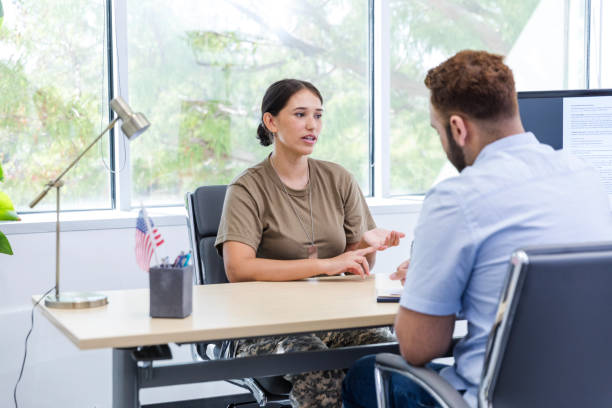 istock Female soldier lists assets while talking to male loan officer 1958189455