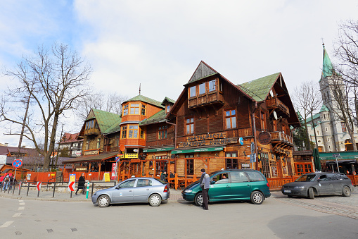Zakopane, Poland - March 06, 2016: View of the wooden building, which was the largest hotel in Zakopane until 1898, and now houses a restaurant called Gazdowo-Kuznia.