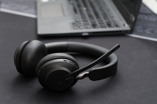 Black wireless headset on black office desk
