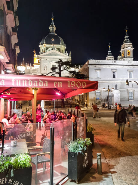 Madrid, Spain - 04 February, 2023: People walking in the Plaza Mayor square by night. The place is a major tourist spot in the city and it is the location of the annual Christmas market.