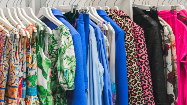 istock Multicolor family clothes on hangers in store 1958238728