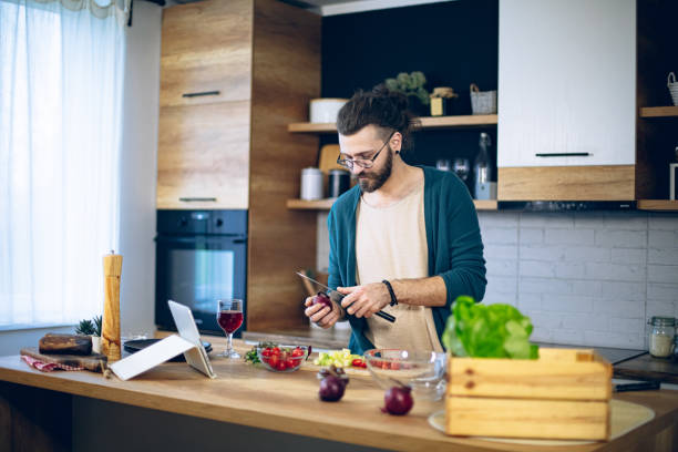 istock Man is preparing a salad in the kitchen 1958247071