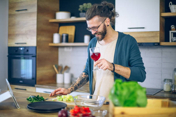 istock Man is preparing food and talking on a tablet 1958247589