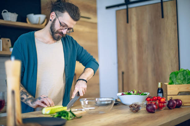 istock Man is preparing a salad in the kitchen 1958256280
