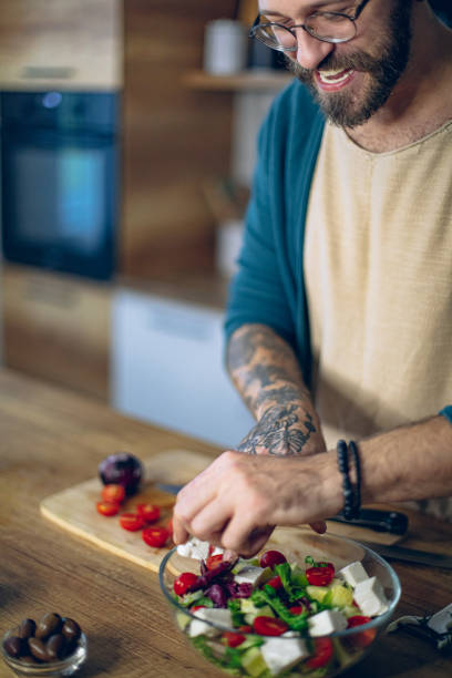 istock Man is preparing a salad in the kitchen 1958258010