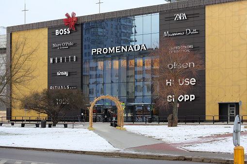 Warsaw, Poland - January 12, 2024: The front wall and entrance door to the modern shopping centre known as the Promenada, housed in a large building.