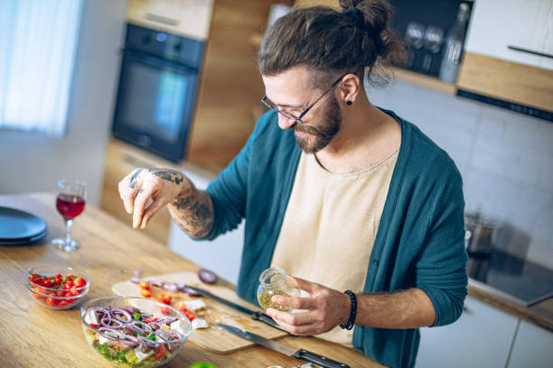 istock Man is preparing a salad in the kitchen 1958265367