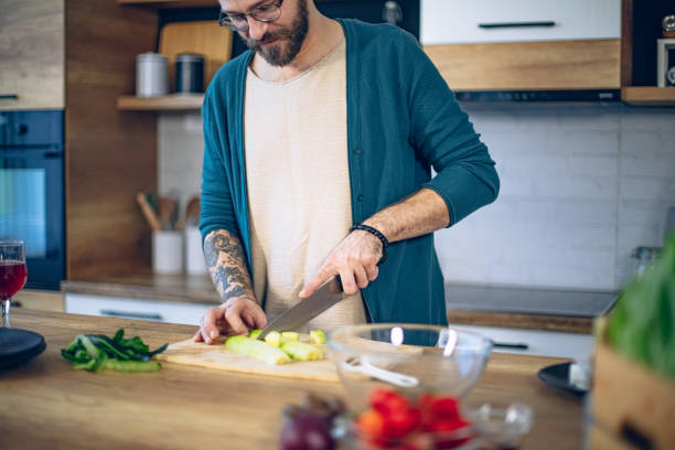 istock Man is preparing a salad in the kitchen 1958270096