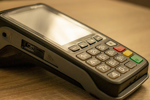 Closeup shot of a payment terminal, showcasing modern banking concept.