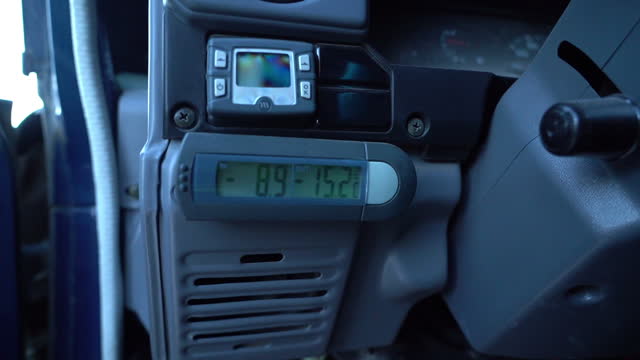 digital car thermometer showing very deep and cold temperatures of minus degrees.
