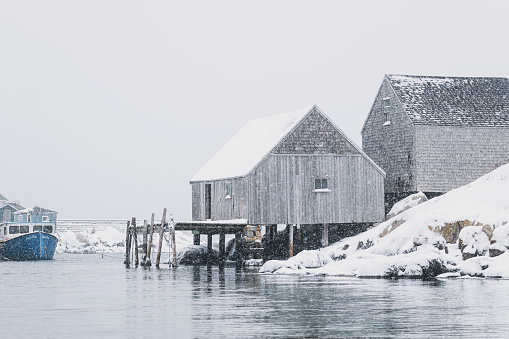 Lighthouse in a calm and desolate winter landscape.