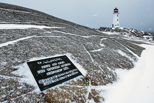 At Peggy's Cove Lighthouse, a plaque alerts visitors of the slippery black rocks that  are along the coastline.