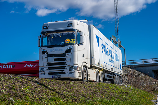 Gothenburg, Sweden - March 27 2023: Large white Scania truck and trailer on a parking lot.