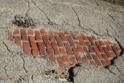 Brick road beneath asphalt overlayer