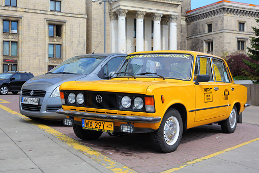 Warsaw, Poland - April 16, 2016: The historic Fiat 125p, an icon of Polish motoring. This car advertises a tourist company famous for organising individual tours for tourists coming to the city.