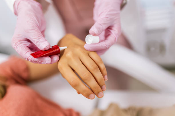 istock Doctor applying protective cream on patient's hands 1958296843
