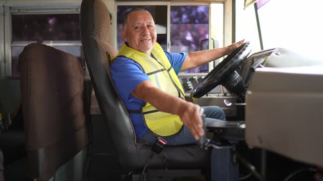 Portrait of a senior bus driver man driving a bus on the city
