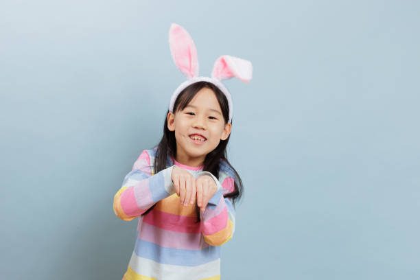 medium shot young girl celebrating Easter against plain background
