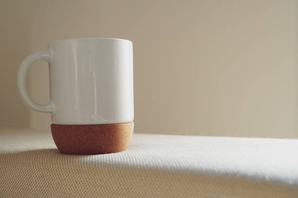 istock A white mug with a cork bottom on white sofa in the morning light 1958316913