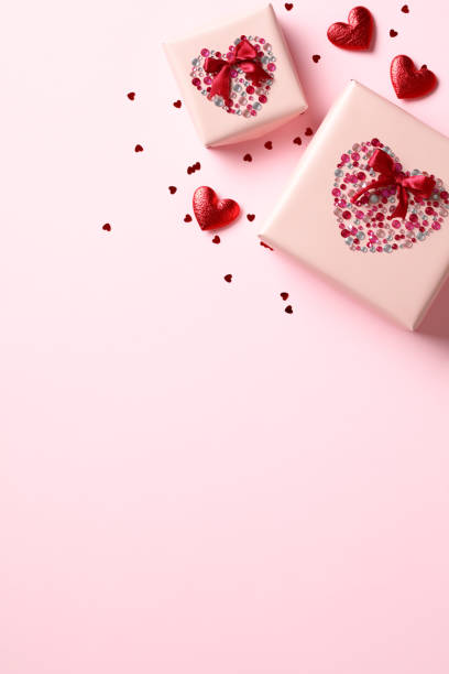 istock Valentine's Day vertical flat lay composition with festive gift boxes decorated glitter rhinestones on pastel pink background. 1958324103
