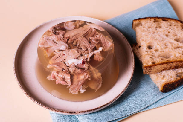 Jelly with meat, beef aspic. Portion on plate with bread. Jelly with meat, beef aspic, traditional dish. portion on plate with homemade bread. aspic stock pictures, royalty-free photos & images