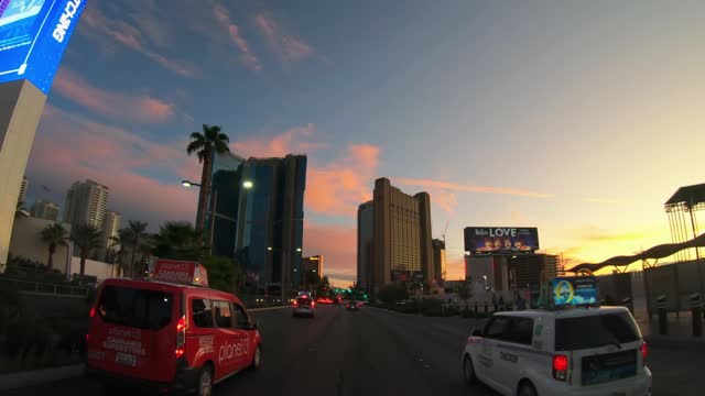 Las Vegas, Amazing driver POV of the boulevard towards downtown Las Vegas and the sunset. Palm trees, party, casino buildings concept