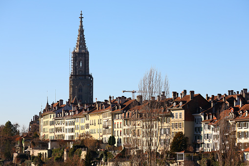 Bern, Switzerland - December 26, 2015: The medieval city centre of Bern can be seen slightly in the distance. The cathedral of Bern towers over the city.