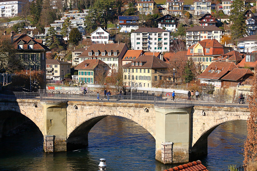 Bern, Switzerland - December 26, 2015: The Untertorbruecke (Lower Gate Bridge), it is a stone arch bridge over the river Aare, it was built in the 15th century, it carries two lanes of traffic and sidewalks.