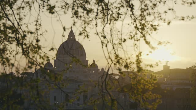 Cinematic establishing shot of Rome skyline with the dome of St Peter's basilica at sunset in Rome,Vatican, Italy